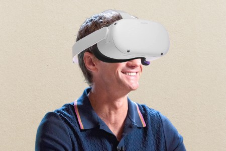 Man with virtual reality headset on beige background