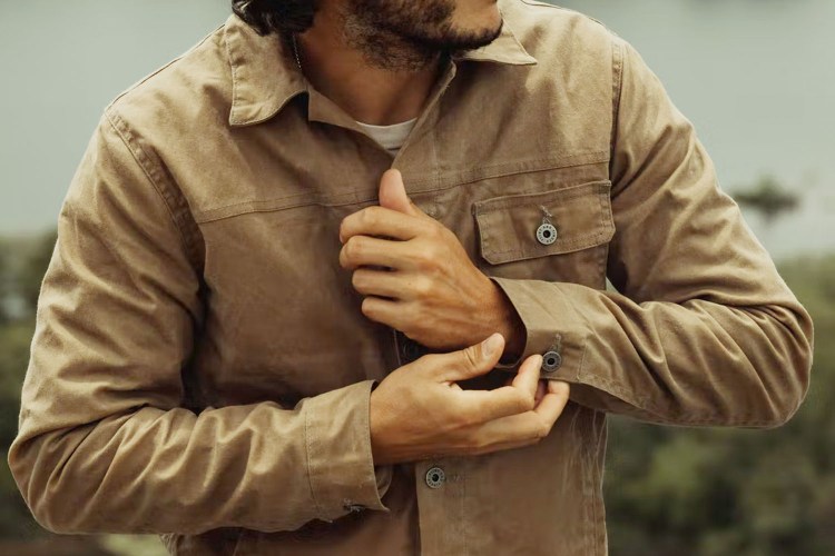 Man wearing field tan Huckberry Waxed Trucker Jacket